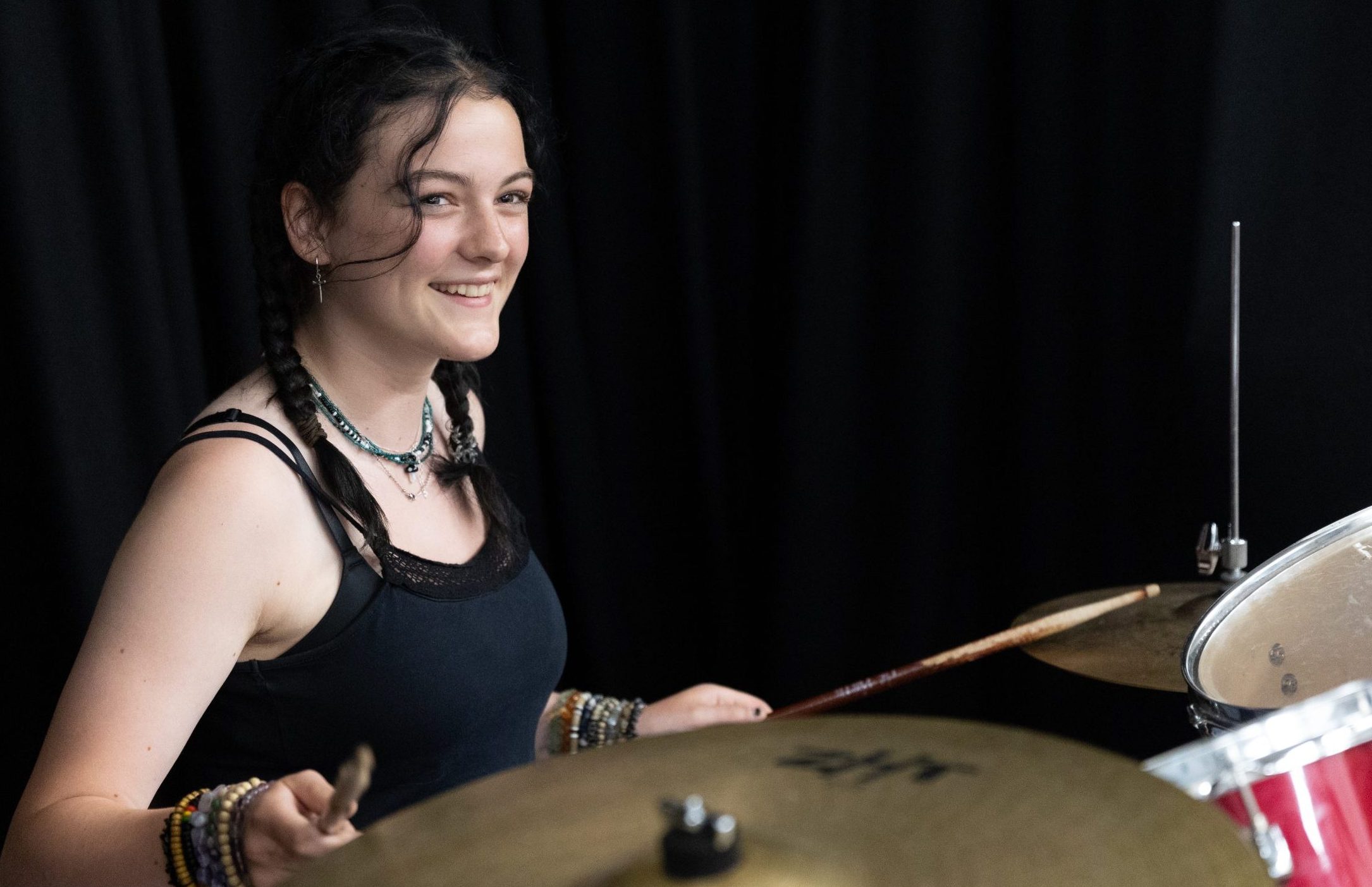 Young woman playing drum kit