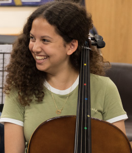 Smiling girl with stringed instrument