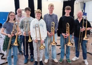 Students holding trombones