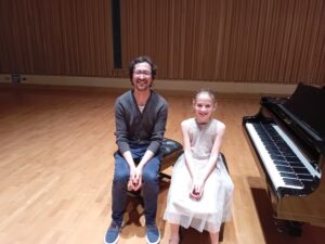 Teacher and student at piano