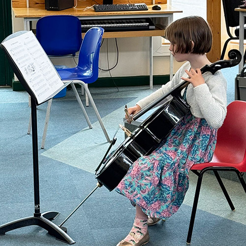 Young student playing cello