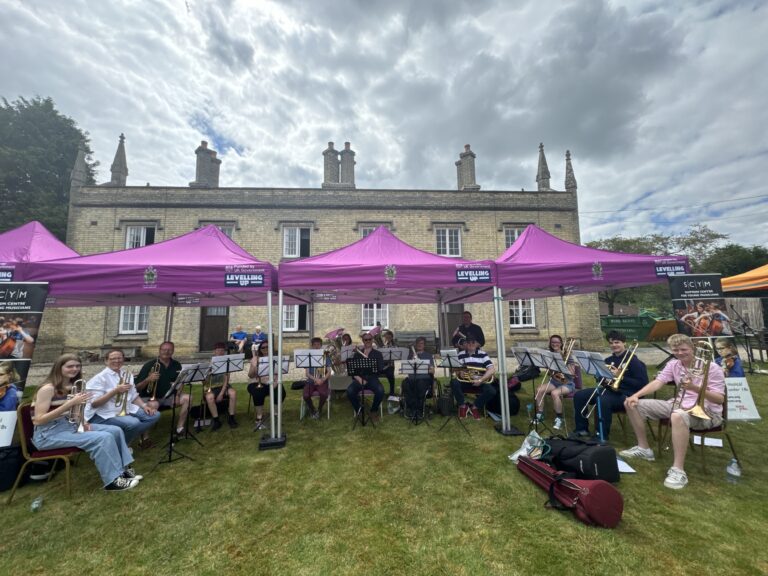 Musicians playing under marquees